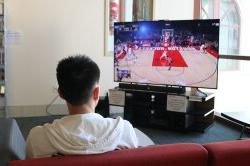 Montclair State University Student Enjoying a game of NBA2K19 in the Equipment Checkout Lounge at the Student Recreation Center Lounge